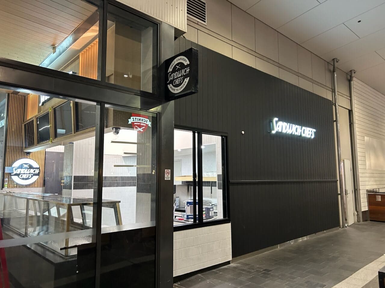 Freshly painted Sandwich Chefs shopfront with matte black cladding and illuminated signage by VD Painting